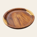 A round wooden serving platter with a rich dark brown center and natural light wood edges, photographed on a clean, light beige background.