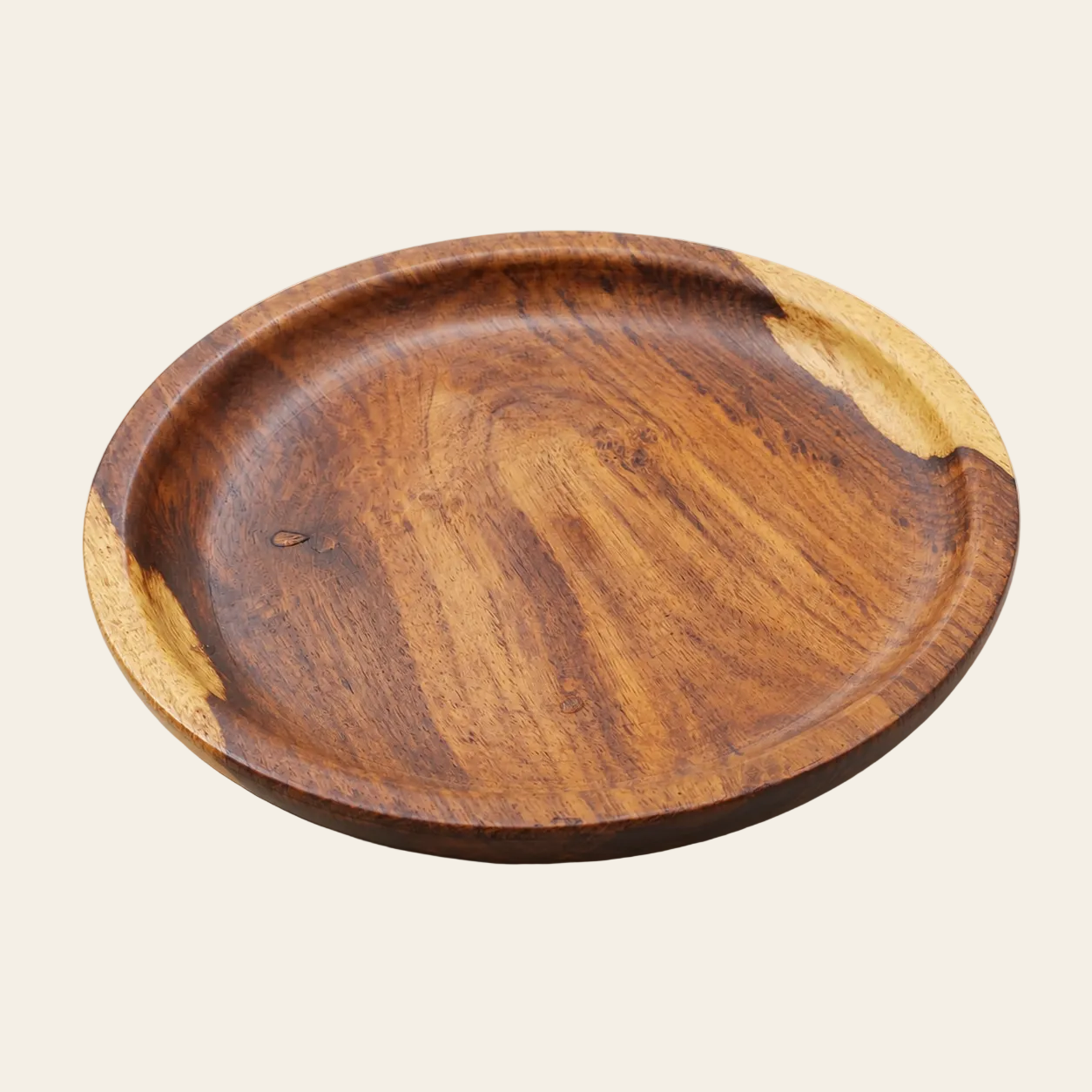 A round wooden serving platter with a rich dark brown center and natural light wood edges, photographed on a clean, light beige background.
